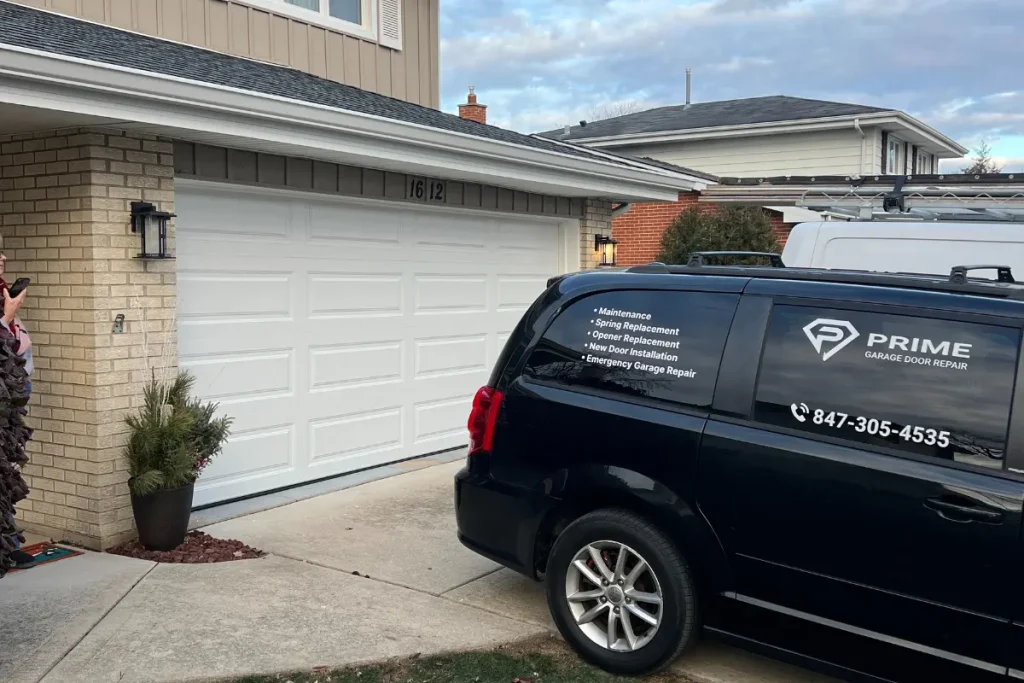 Black car next to the garage doors