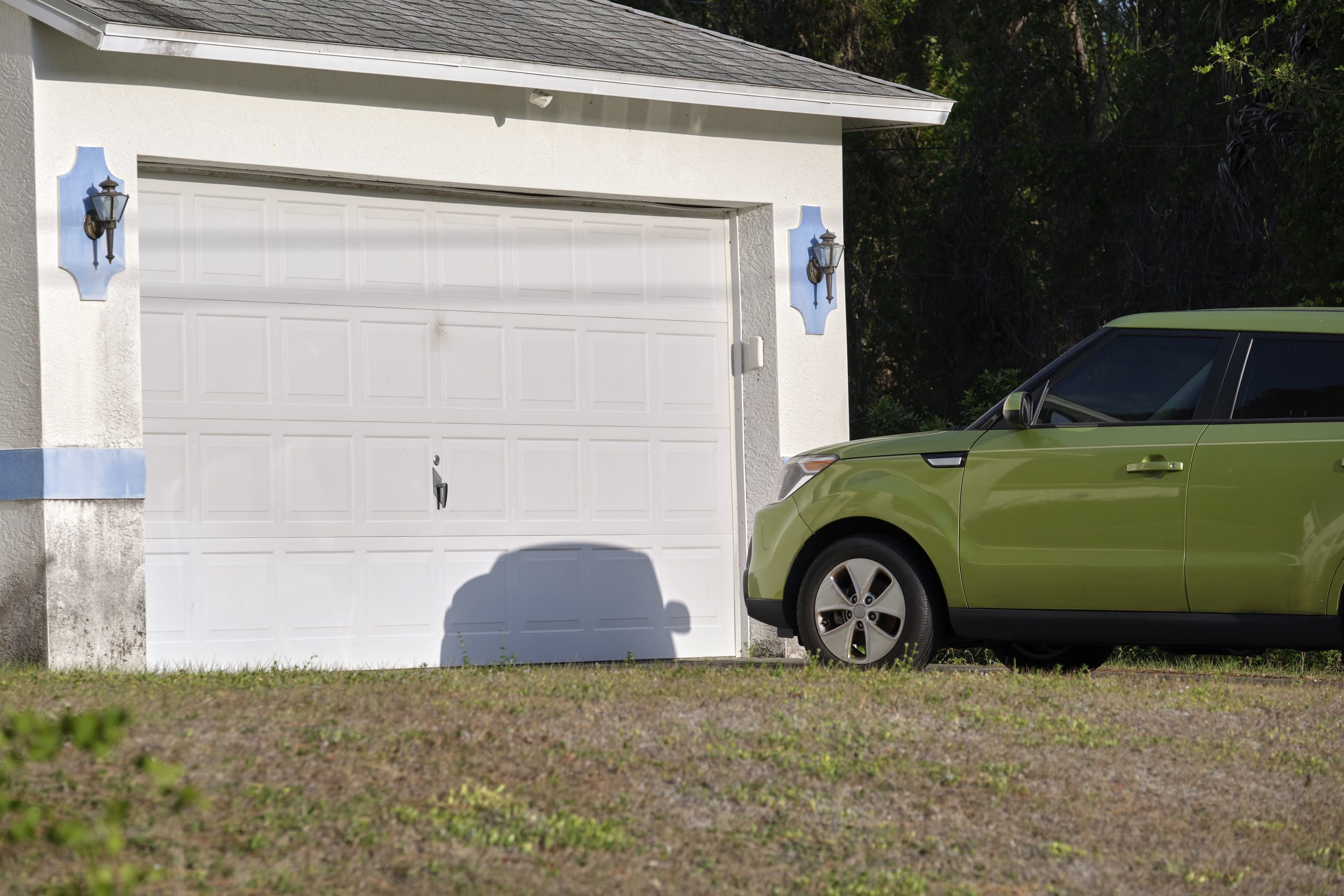 car parked in front of white garage doors