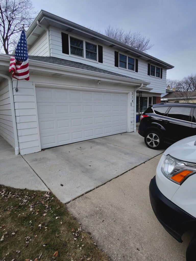 closed garage door with cars outside