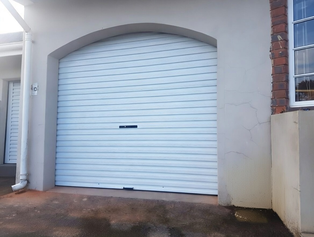 White Roll-Up Shutter Design Fitted Into An Arched Entryway, Showcasing Versatile Garage Door Options Installed By Lead Contractor Dmytro Shevchenko In North West Chicago.
