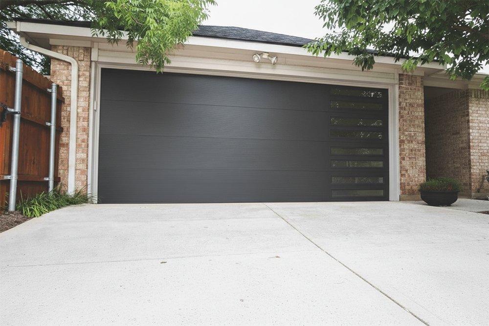 Modern Black Garage Door With Horizontal Panels And Slim Vertical Windows Installed By Lead Contractor Dmytro Shevchenko In North West Chicago.