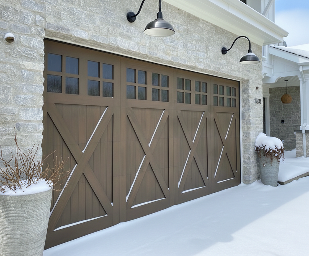An Elegant Brown Wood-Tone Carriage-Style Garage Door Featuring X-Brace Details And Upper Windows, Set Against A Light Stone Exterior During A Snowy Winter Day. This Custom Installation Demonstrates The Stylish Garage Door Options Provided By Lead Contractor Dmytro Shevchenko For Homes In North West Chicago.