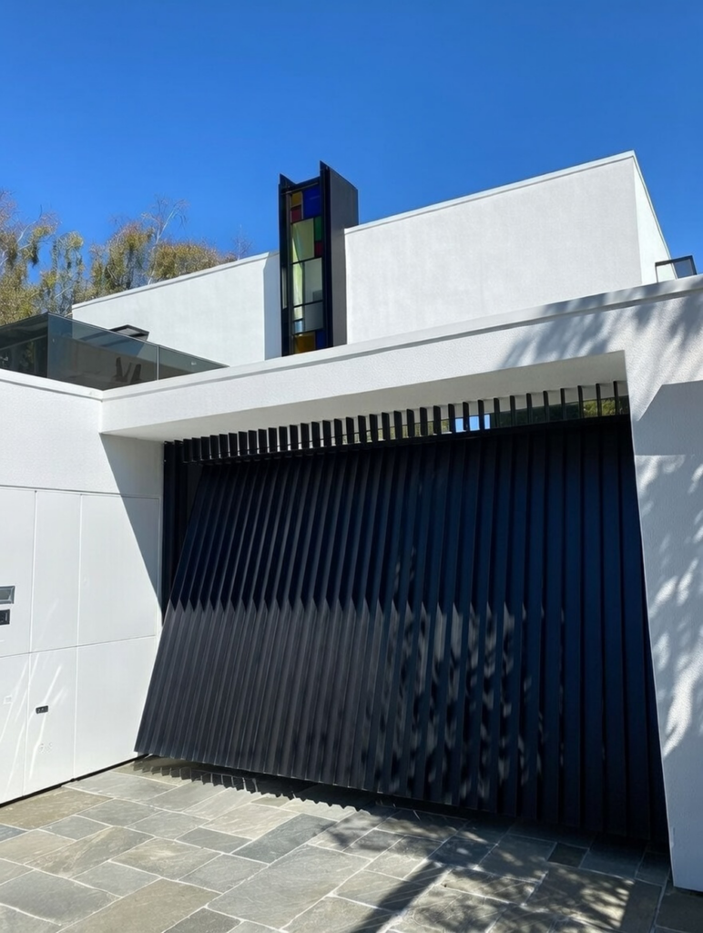 Contemporary White Home Featuring A Black Vertical Slat Tilt-Up Design As An Example Of Custom Garage Door Options, Installed By Lead Contractor Dmytro Shevchenko In North West Chicago.