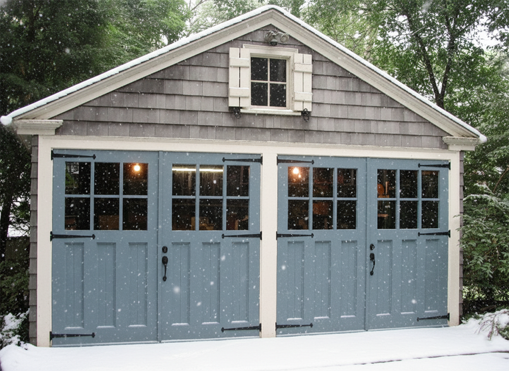 Light Blue Carriage-Style Garage Doors With Window Panels On A Detached Garage During Winter, Showcasing Custom Garage Door Options Provided By Lead Contractor Dmytro Shevchenko For Homes In North West Chicago.