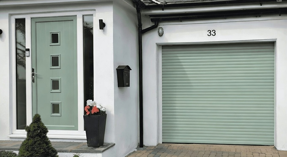 New Style Garage Doors: 2026 Trends &Amp; Modern Designs For Chicago Homes White Home Exterior Featuring A Sage Green Roller Shutter Design That Matches The Front Door, Showcasing Coordinated Garage Door Options Installed By Lead Contractor Dmytro Shevchenko In North West Chicago.