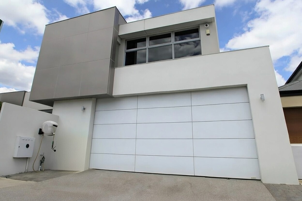 Style Garage Doors: 2026 Guide To Popular Designs &Amp; Trends For Chicago Homes Modern Minimalist Home Exterior Featuring A Sleek White Flush-Panel Design As An Example Of Contemporary Garage Door Options, Installed By Lead Contractor Dmytro Shevchenko In North West Chicago.