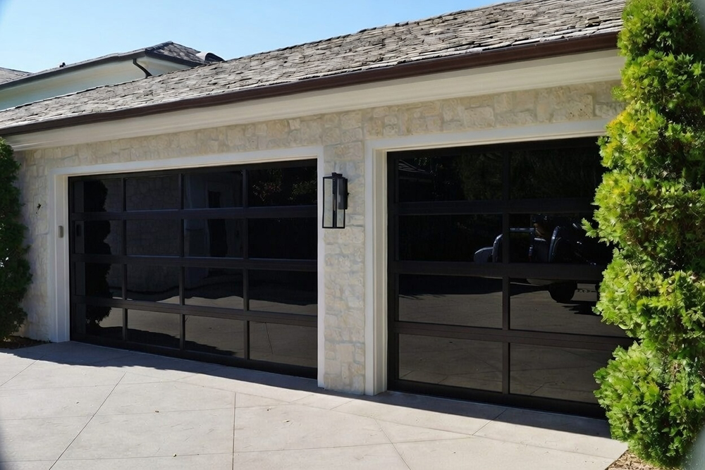 Light Stone Home Exterior Featuring Two Modern Black Glass Garage Door Designs, Installed By Lead Contractor Dmytro Shevchenko In North West Chicago.