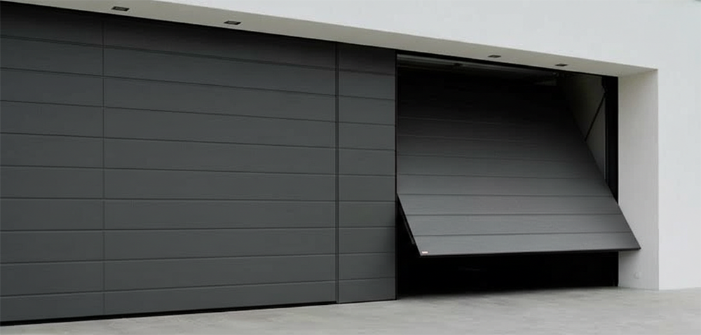 A Sleek, Modern Dark Grey Horizontal Panel Garage Door With One Section Partially Open, Showcasing The Contemporary Garage Door Options Provided By Lead Contractor Dmytro Shevchenko In North West Chicago.