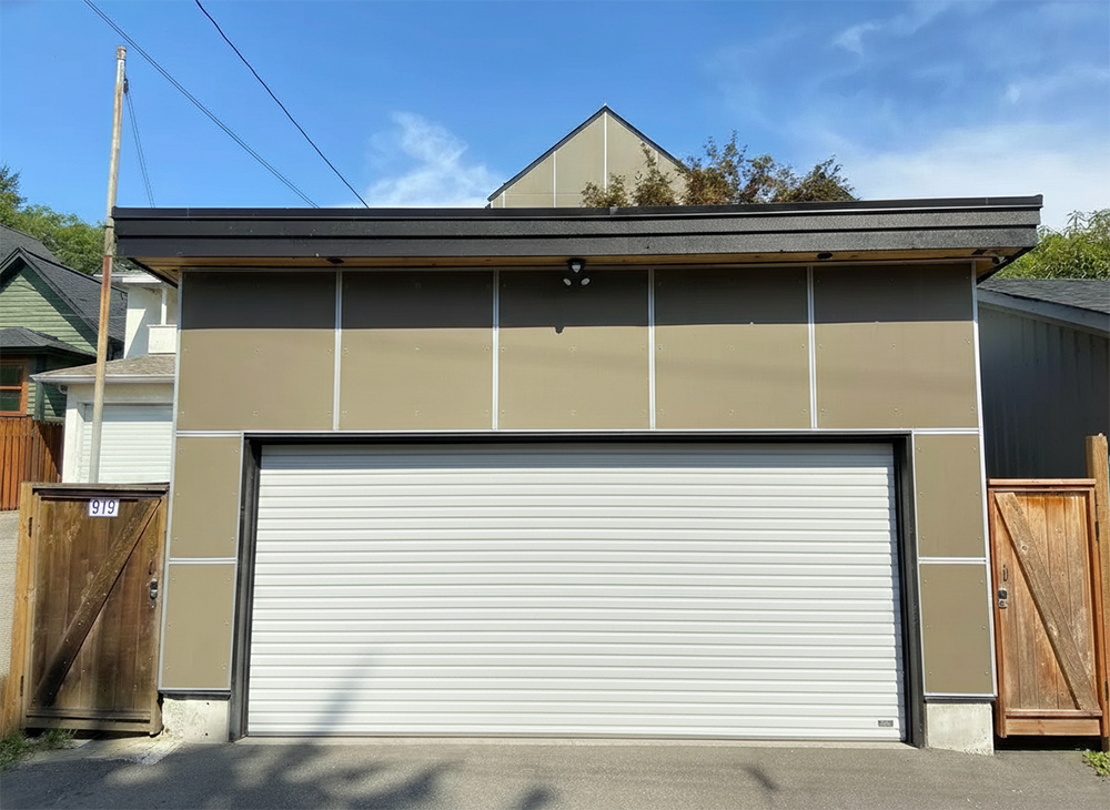 A Modern Detached Garage With Tan Architectural Panels And A White Horizontal-Slat Garage Door, Showcasing The Sleek Garage Door Options Available Through Lead Contractor Dmytro Shevchenko In North West Chicago.