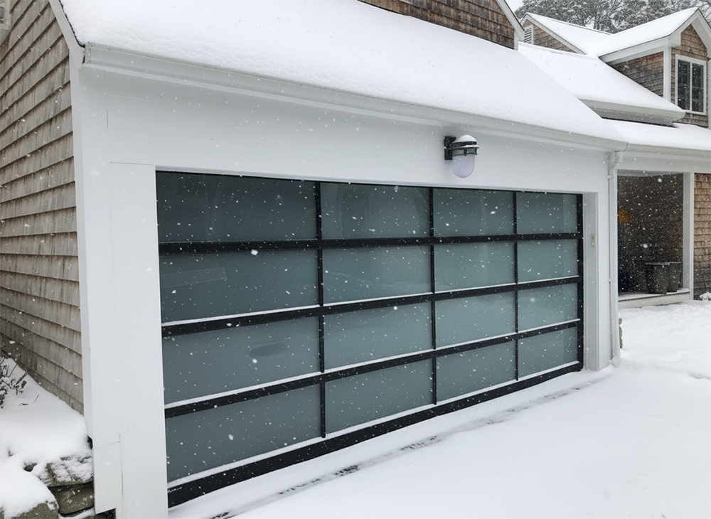 Modern Frosted Glass And Black Frame Garage Door In A Winter Setting, Representing Stylish Garage Door Options Available Through Lead Contractor Dmytro Shevchenko In The North West Chicago Area.