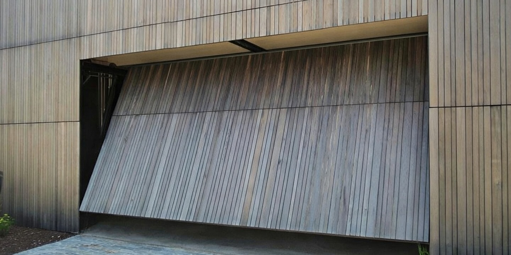 Modern Vertical Wood Slat Tilt-Up Design That Blends Seamlessly With The Facade, Serving As A Unique Example Of Custom Garage Door Options Installed By Lead Contractor Dmytro Shevchenko In North West Chicago.