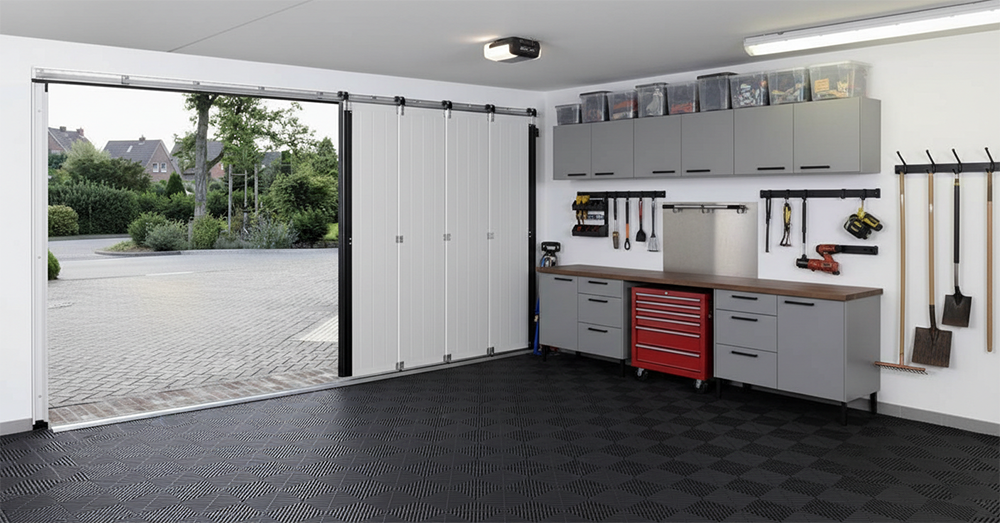 Organized Garage Interior Featuring A White Side-Sliding Design As A Unique Example Of Space-Saving Garage Door Options, Installed By Lead Contractor Dmytro Shevchenko In North West Chicago.