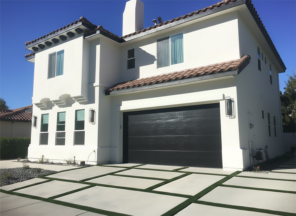 Modern Black Textured Garage Door With Contemporary Horizontal Panel Design And Water-Like Ripple Finish, Installed On A Luxurious White Stucco Mediterranean-Style Home With Red Tile Roof – Professional Installation By Lead Contractor Dmytro Shevchenko, North West Chicago