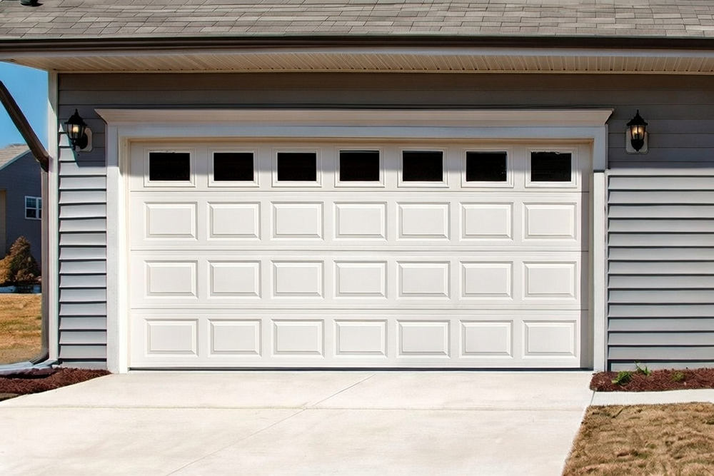 Classic White Raised-Panel Design With Top Windows As An Example Of Traditional Garage Door Options, Installed By Lead Contractor Dmytro Shevchenko In North West Chicago.
