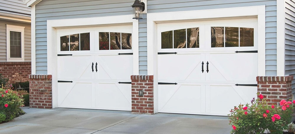Style Garage Doors: 2026 Guide To Popular Designs &Amp; Trends For Chicago Homes Side-By-Side White Carriage-House Style Designs Featuring Crossbuck Panels And Arched Windows As Elegant Garage Door Options, Installed By Lead Contractor Dmytro Shevchenko In North West Chicago.