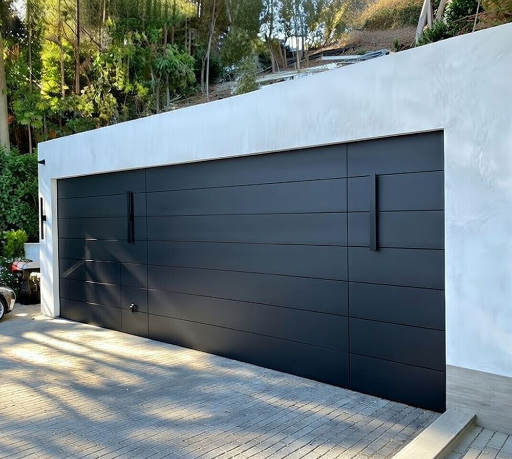 Sleek Modern Single Wide Garage Door In Matte Black With Horizontal Panel Design And Minimalist Vertical Black Hardware, Flush-Mounted On A Contemporary White Stucco Wall In A Luxurious Setting. Garage Door Installation By Lead Contractor Dmytro Shevchenko In North West Chicago.
