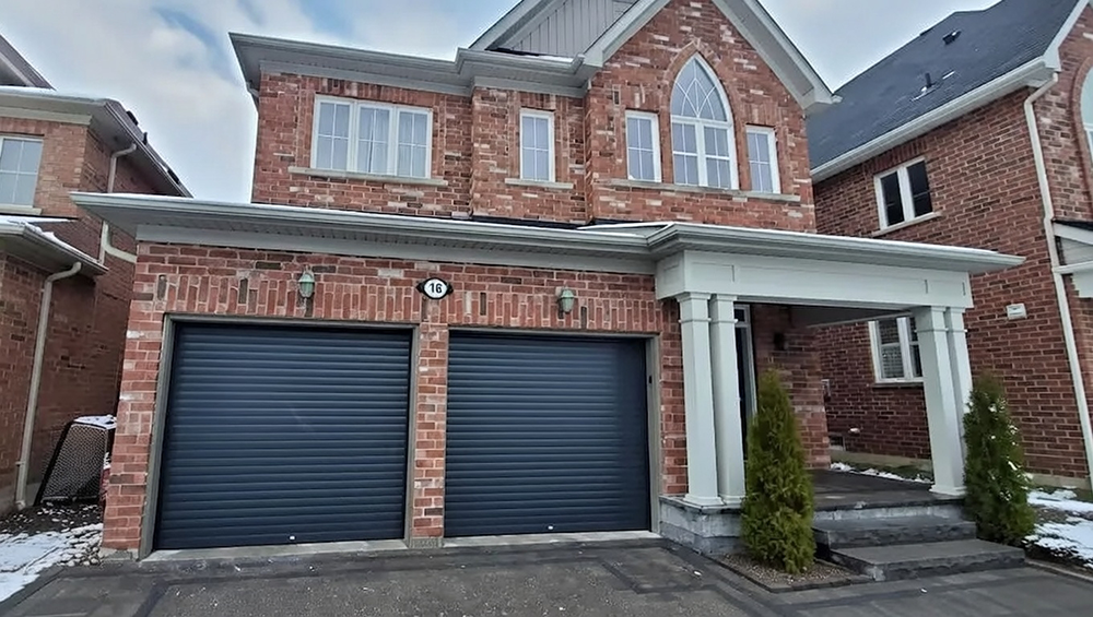 Residential Garage Door Types: A Complete 2026 Guide For Chicago Homeowners Luxury Two-Car Residential Home With Dark Navy Blue Horizontal Slat Roll-Up Garage Doors Installed On A Modern Red Brick Two-Story House With Covered Porch And White Columns, Address 16 Visible, Snowy Front Yard, North West Chicago Area. Lead Contractor Dmytro Shevchenko – Contemporary Residential Garage Door Types.