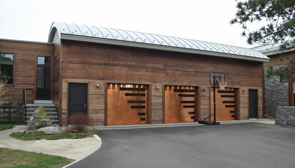 Residential Garage Door Designs: The Ultimate 2026 Style &Amp; Performance Guide Custom Modern Residential Garage Door Designs In Warm Copper-Bronze Finish With Horizontal Black Window Slits And Integrated Lighting On A Detached Multi-Bay Garage With Cedar Wood Siding And Curved Metal Roof, Installed By Lead Contractor Dmytro Shevchenko In North West Chicago