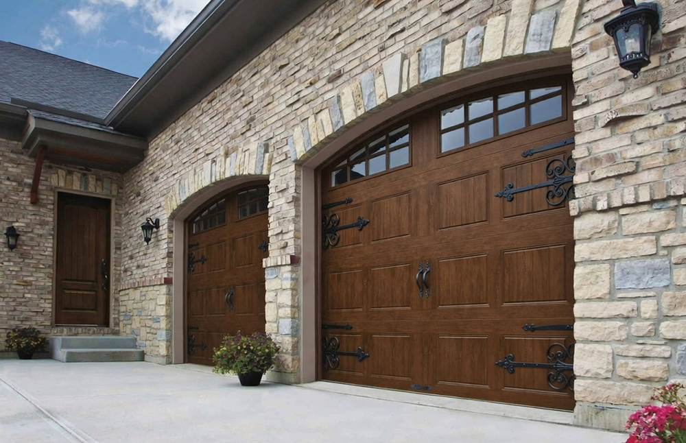 Types Of Garage Doors With Pictures: A Visual Gallery For 2026 Stunning Arched Carriage-Style Wooden Garage Doors In Rich Brown Finish With Decorative Black Hardware On A Luxury Brick Home, Showcasing Popular Types Of Garage Doors With Pictures – Expertly Installed By Lead Contractor Dmytro Shevchenko, North West Chicago