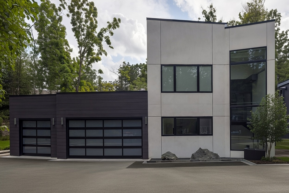Sleek Modern Double Garage Door In Matte Black With Horizontal Glass Panels, Installed On A Contemporary Two-Story Home Featuring Dark Siding And Large Geometric Windows In North West Chicago. Garage Door Installation By Lead Contractor Dmytro Shevchenko.