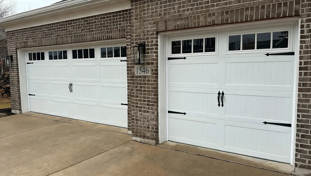 What Are The 5 Types Of Garage Doors? A 2026 Homeowner’s Guide Two White Carriage-Style Garage Doors Installed By Lead Contractor Dmytro Shevchenko In North West Chicago, Serving As A Visual Example For The Article What Are The 5 Types Of Garage Doors.
