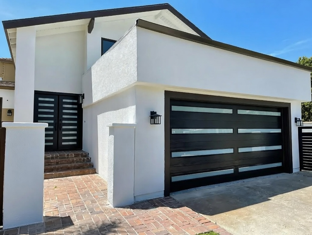What Is A Garage Door Called? A Guide To Names And Terminology Example Of A Modern Black Sectional Garage Door (Commonly Called A Sectional Overhead Garage Door) With Horizontal Panels And Integrated Frosted Glass Inserts For A Contemporary Look, Installed On A Stylish Two-Story Stucco Home Exterior, By Lead Contractor Dmytro Shevchenko In North West Chicago. What Is A Garage Door Called? This Type Is Known As A Sectional Garage Door.