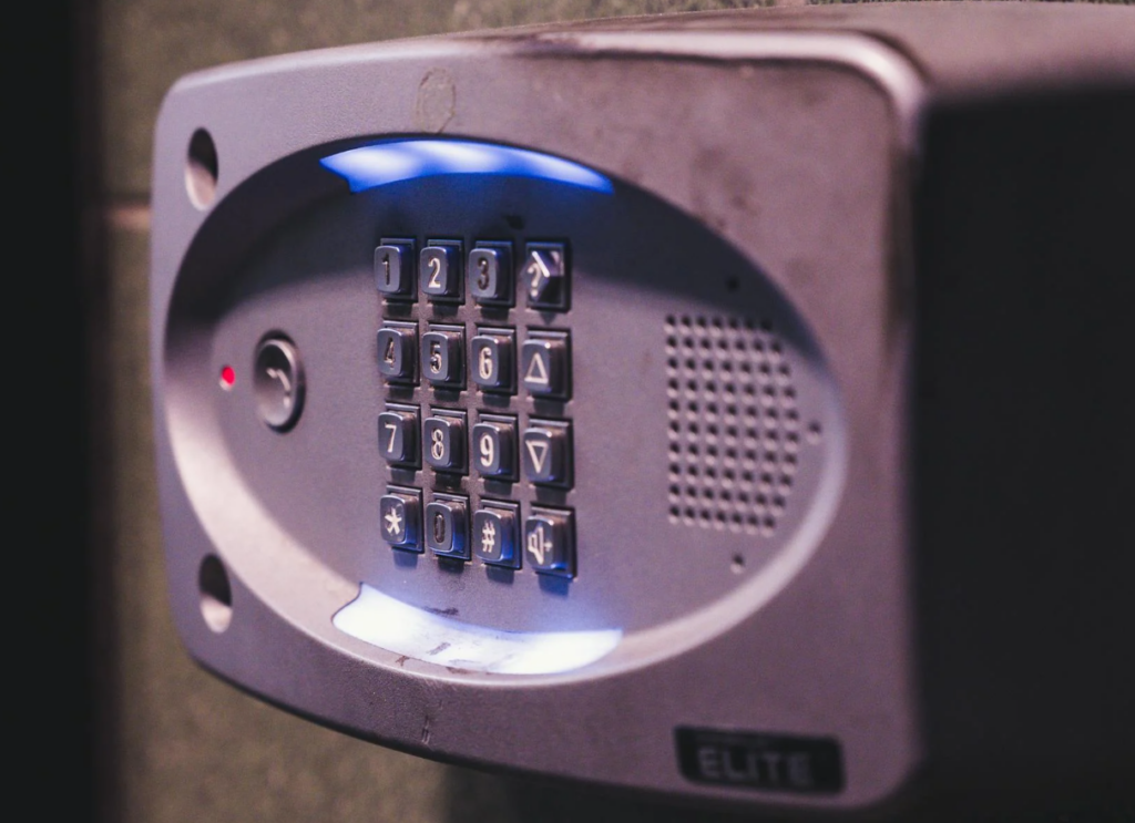 How To Change A Garage Door Code Hand Entering A New Pin On An Exterior Wireless Keypad To Change The Garage Door Code